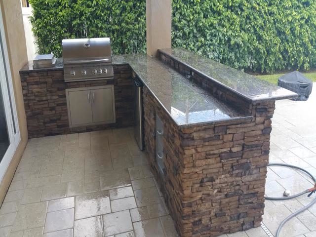 Cliff's Pools & Patios modern outdoor kitchen with travertine counter