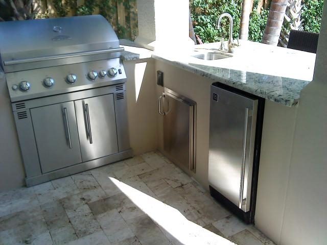 Cliff's Pools & Patios sleek stainless outdoor kitchen with black granite