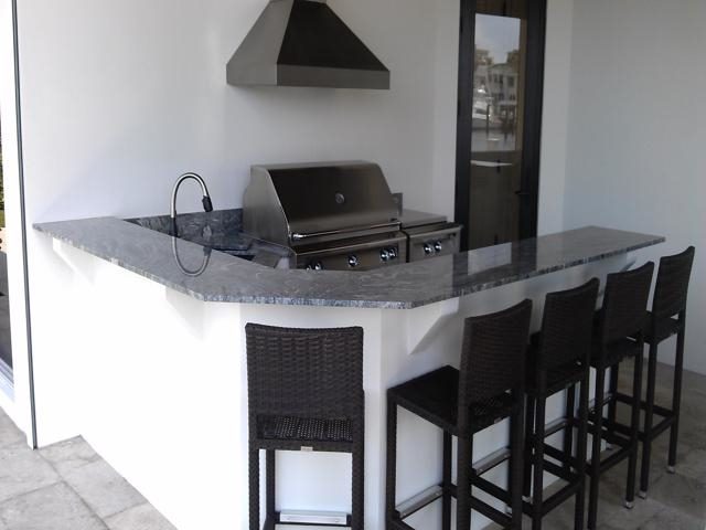 Cliff's Pools & Patios dark granite peninsula with stainless - serving Cooper City, FL