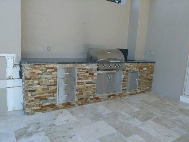 Cliff's Pools & Patios clean modern outdoor kitchen build - serving Royal Palm Beach, FL