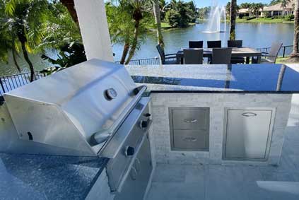 Custom-designed outdoor kitchen with stone countertops by Cliff's Pool in South Florida