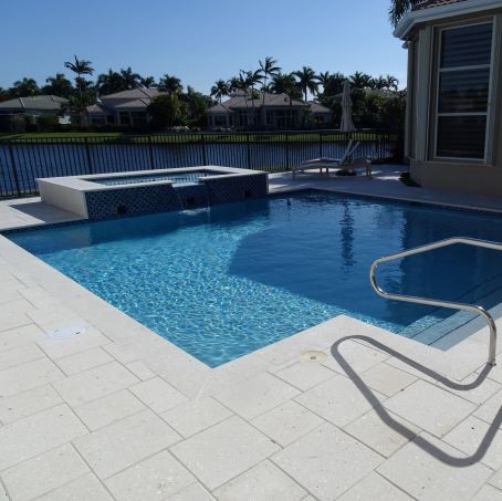 Artistic pavers surrounding a modern pool design by Cliff's Pool in South Florida